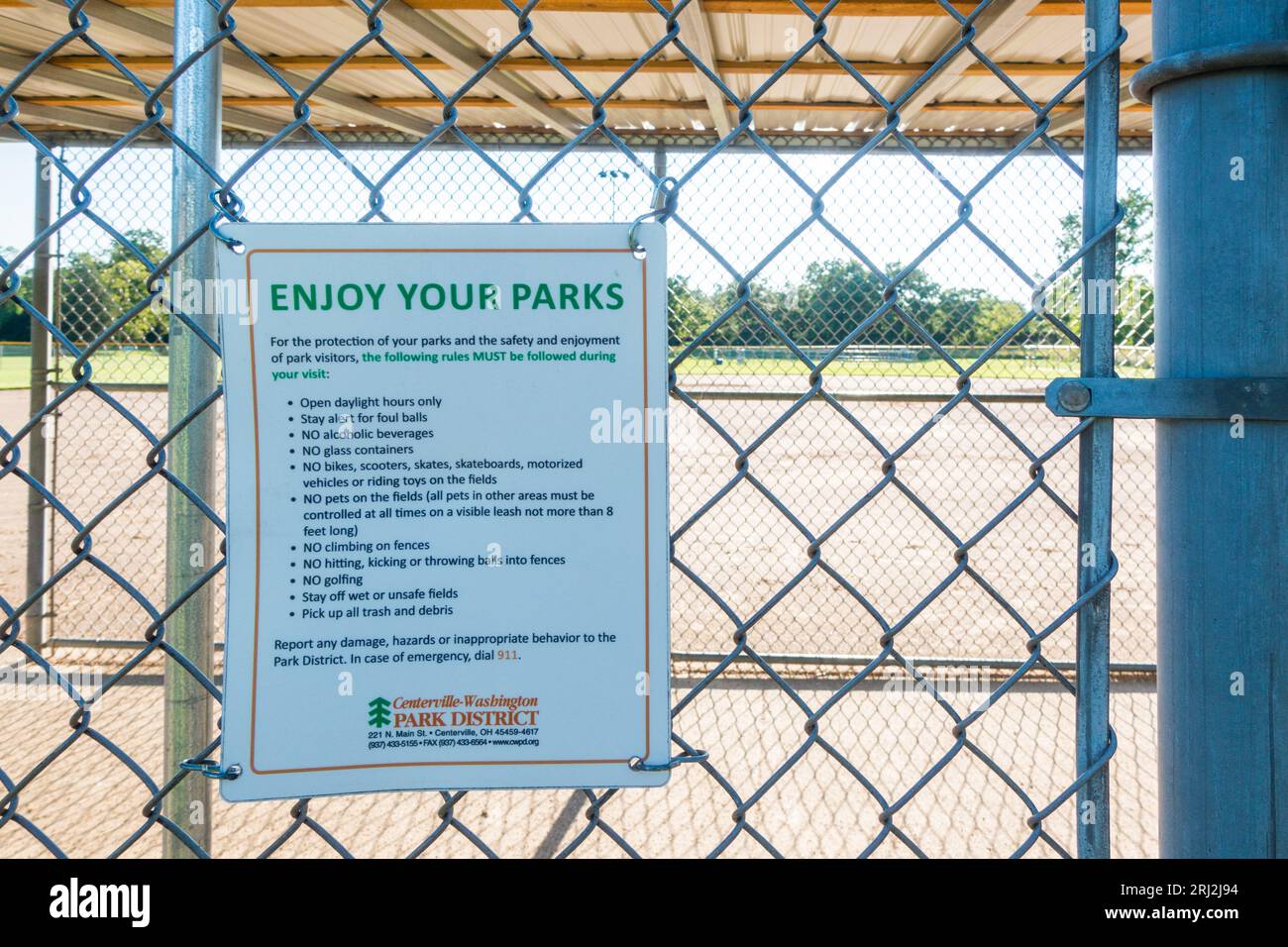 Enjoy your Parks notice on the fence wire in community park Stock Photo