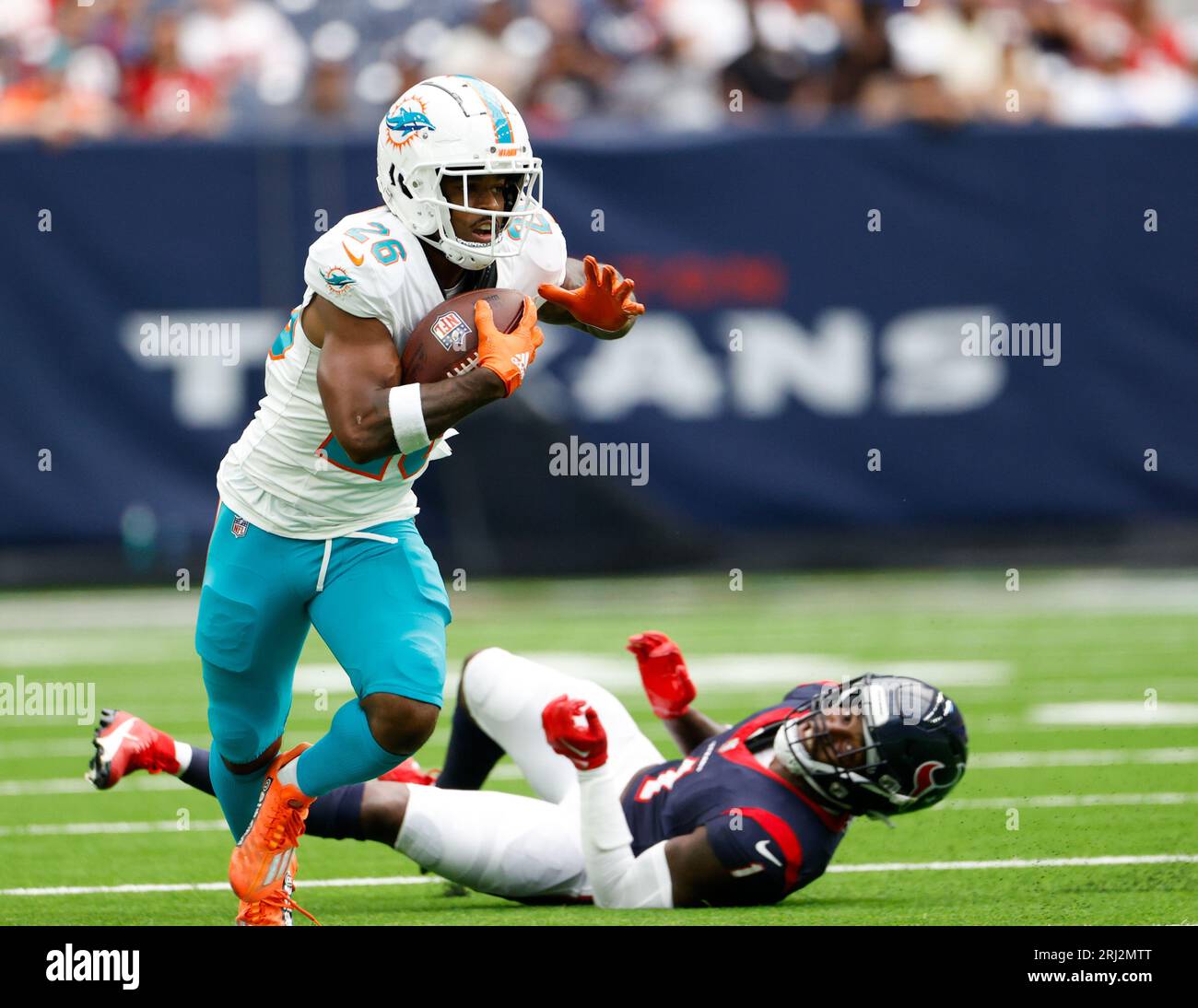 August 19, 2023: Miami Dolphins running back Salvon Ahmed (26) carries the  ball as Houston Texans safety Jimmie Ward (1) looks on after missing a  tackle during an NFL preseason game between