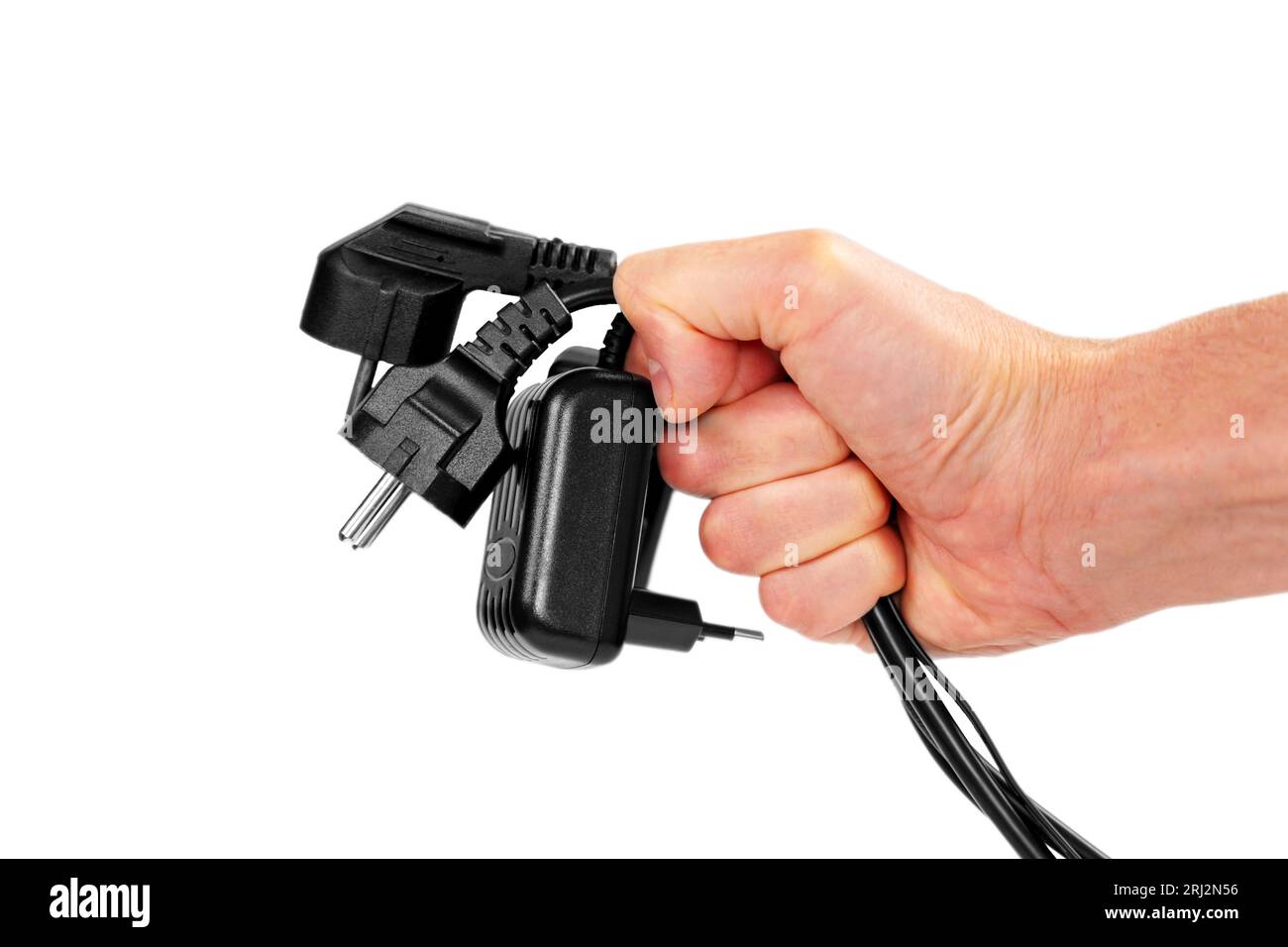 Bundle of disconnected black plugs with cables in hand isolated on white background Stock Photo