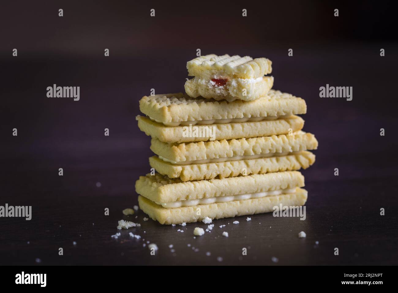 Raspberry creams, raspberry cream sandwich biscuits stacked on top of