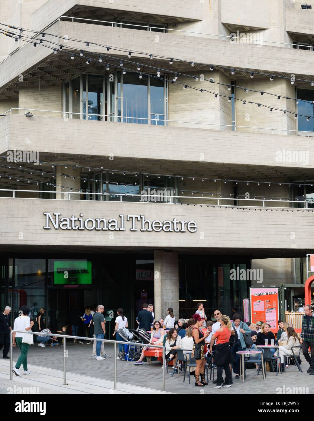 London, UK - July 28, 2023; Crowd at National Theatre in London on a summer evening with venue name Stock Photo