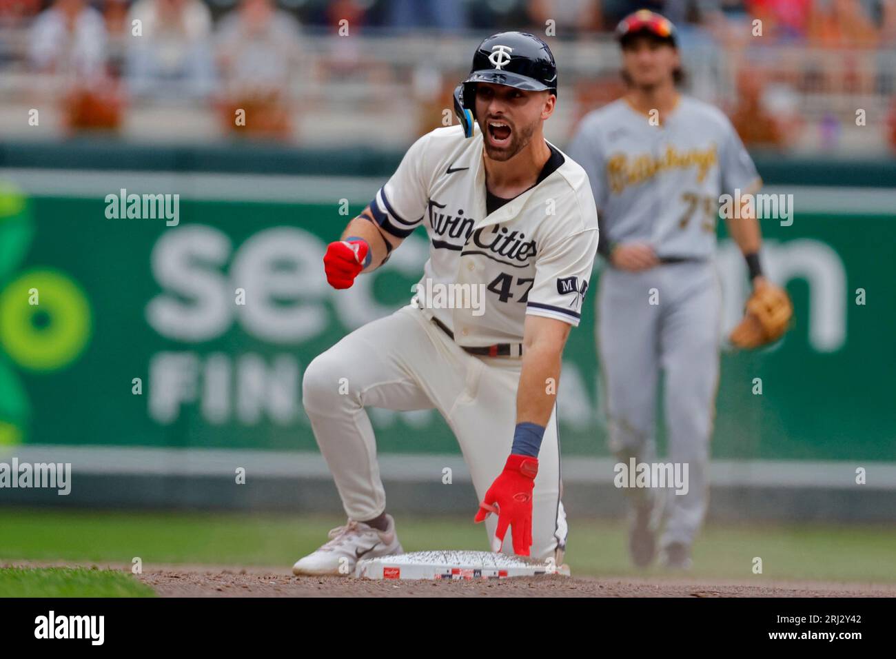 Minnesota Twins' Edouard Julien wears a fishing vest in the dugout