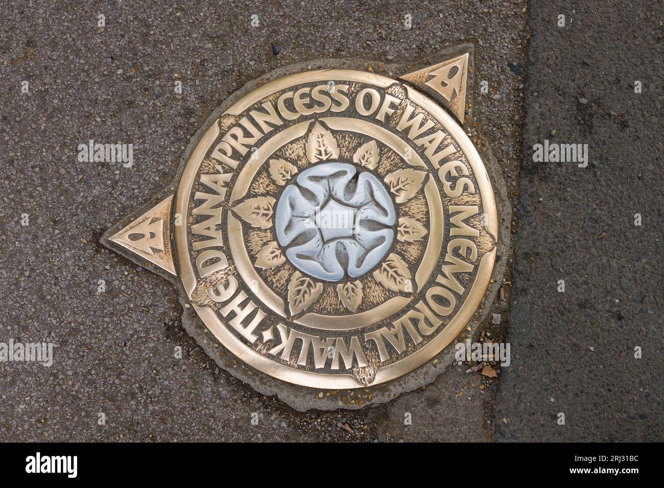 London, UK - July 29, 2023; Metal street symbol on route of The Diana Princess of Wales Memorial Walk with Alec Peever rose emblem Stock Photo
