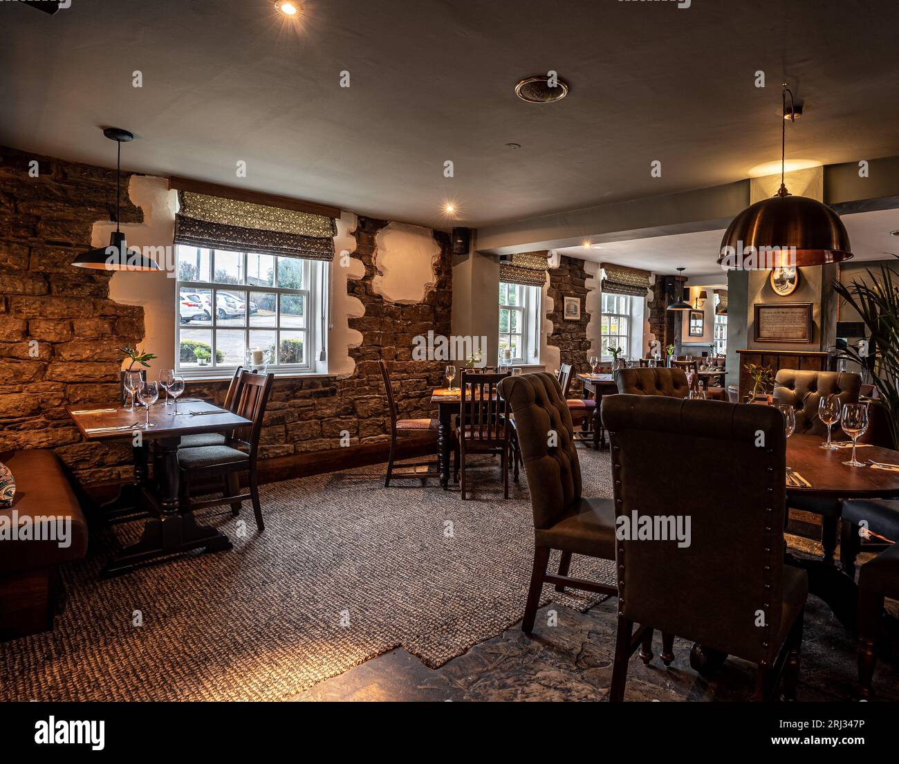 This interior view of a traditional Tudor-style pub offers a warm and cozy atmosphere Stock Photo