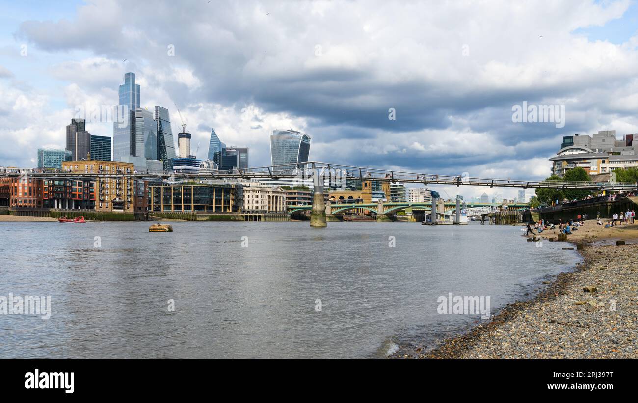 London, UK - July 28, 2023; City of London view across River Thames from Bankside Beach Stock Photo