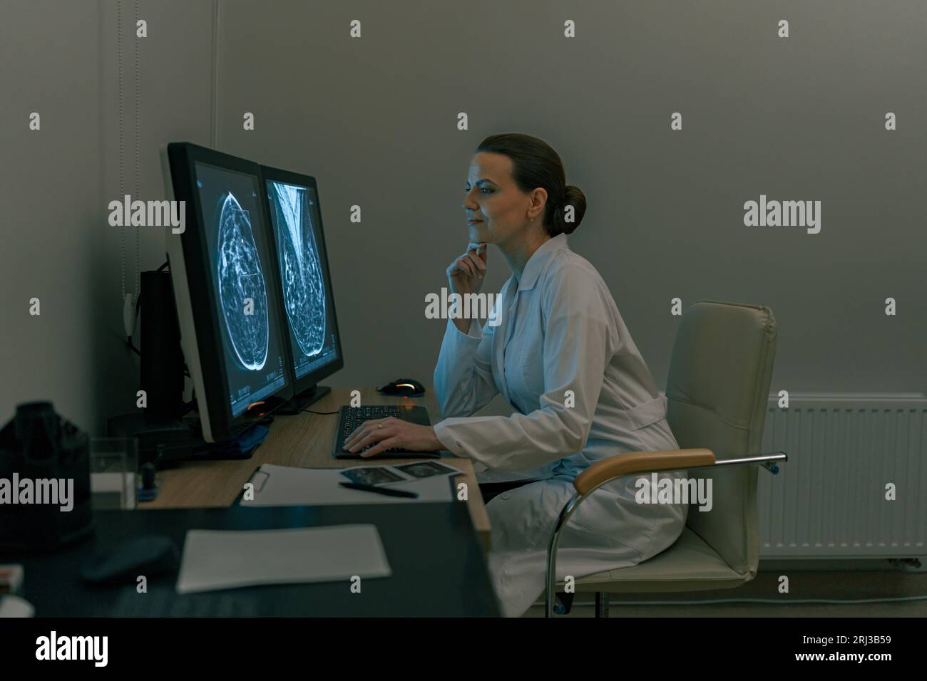 Female doctor neuroscientist analyzing brain scan MRI images in ...