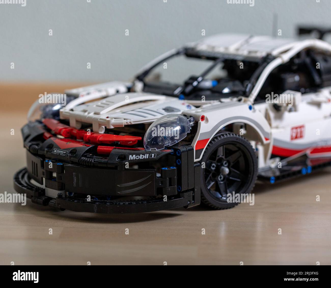 This stock photo features a Lego car built to resemble a racing car, complete with a spoiler and sleek aerodynamic design Stock Photo