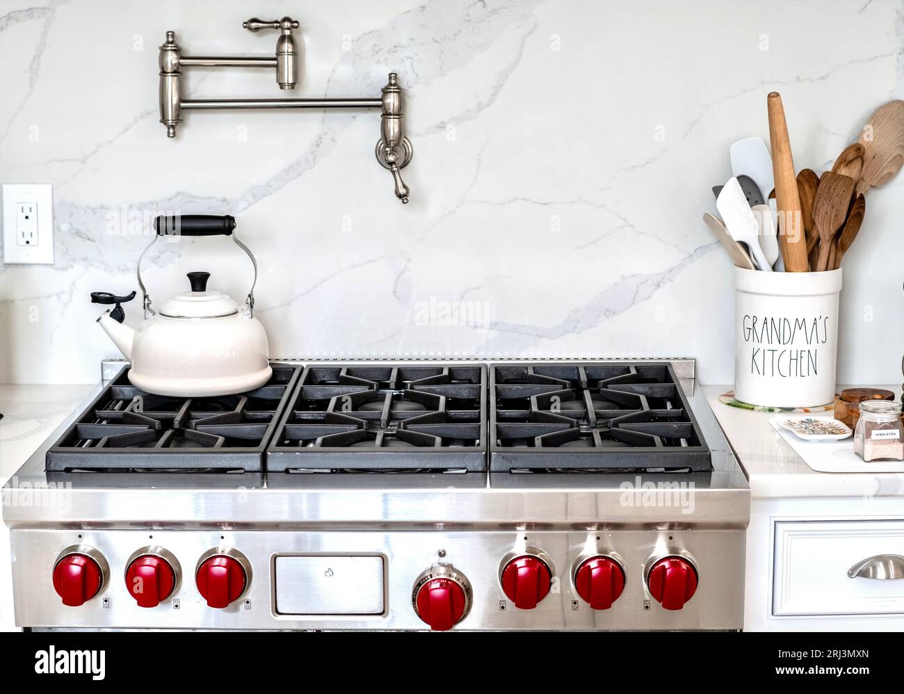 A modern kitchen design with a stove and utensils Stock Photo - Alamy