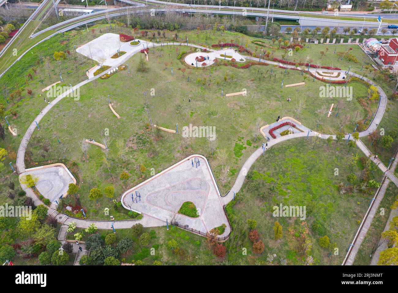 An aerial view of a lush green park with a lake in the center ...
