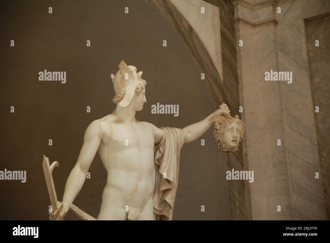 A close-up shot of a marble statue depicting the scene of Perseus holding the head of Medusa Stock Photo