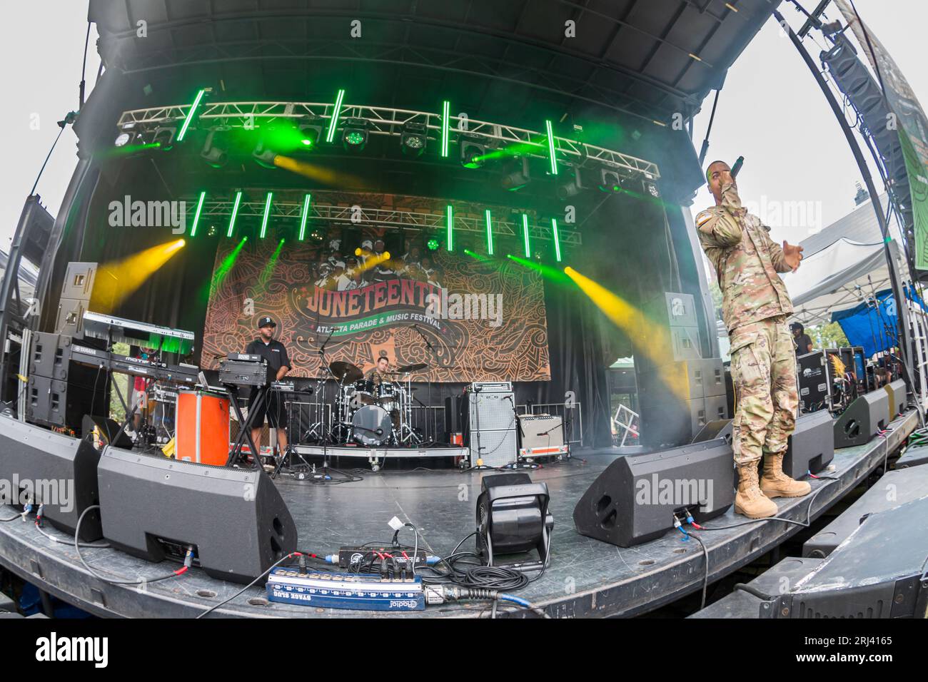 Atlanta, GA / USA – June 17, 2023:  A U.S. Army rapper performs hip hop music wearing his fatigues on the main stage at the Juneteenth Festival in Cen Stock Photo