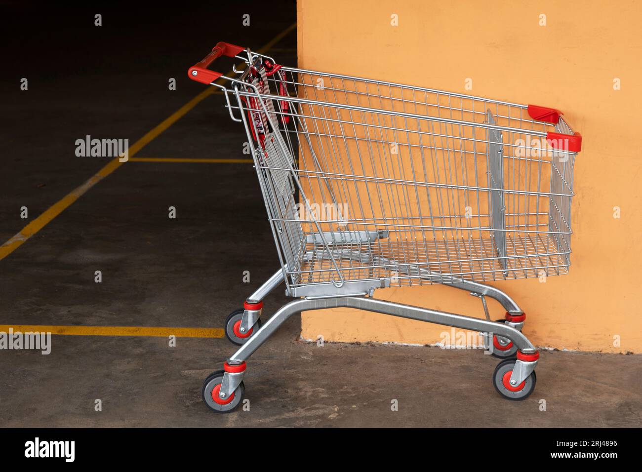 Abandoned shopping cart left in a mall parking lot, signifying neglect