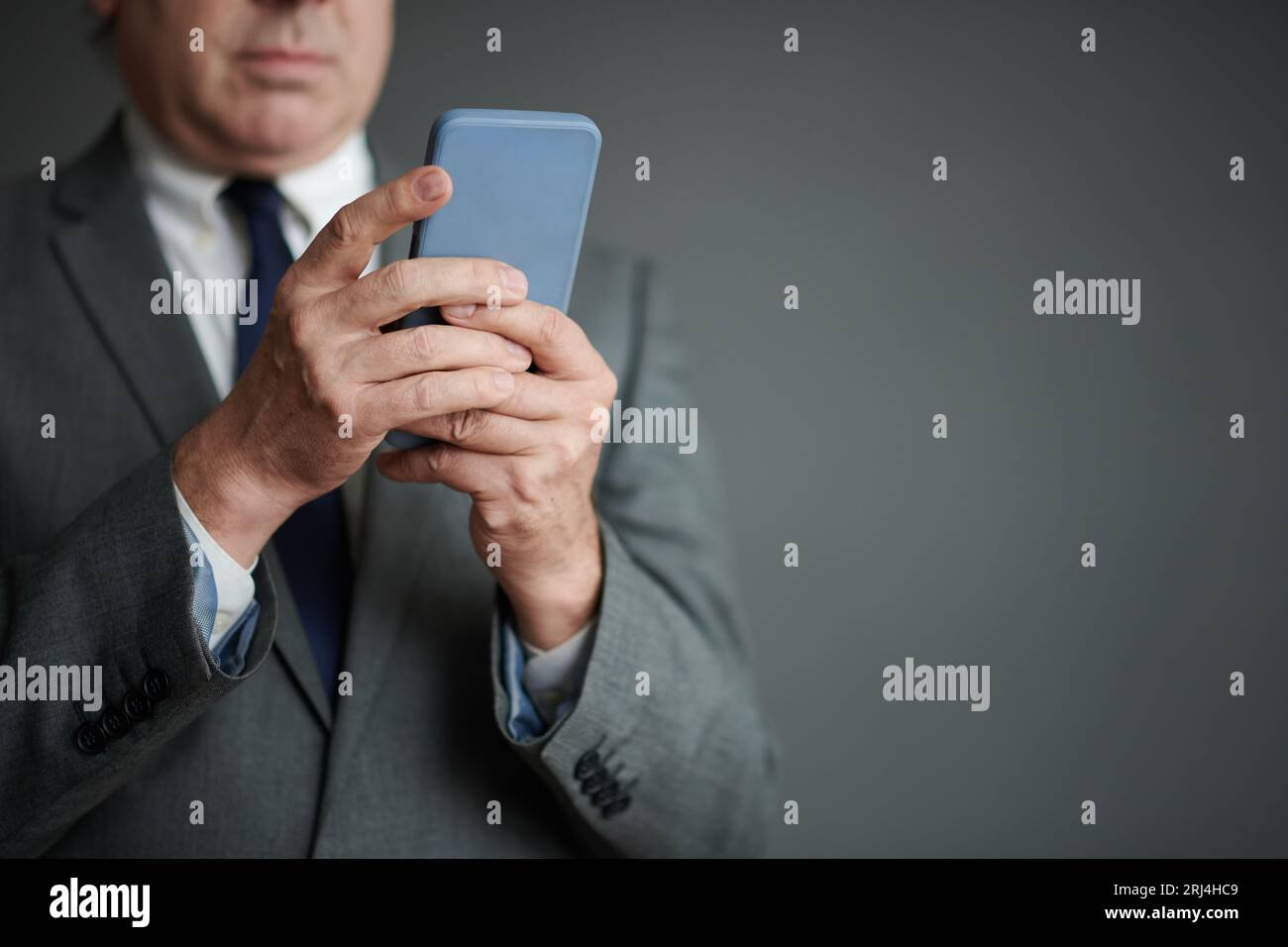 Closeup image of businessman answering text messages from colleagues ...
