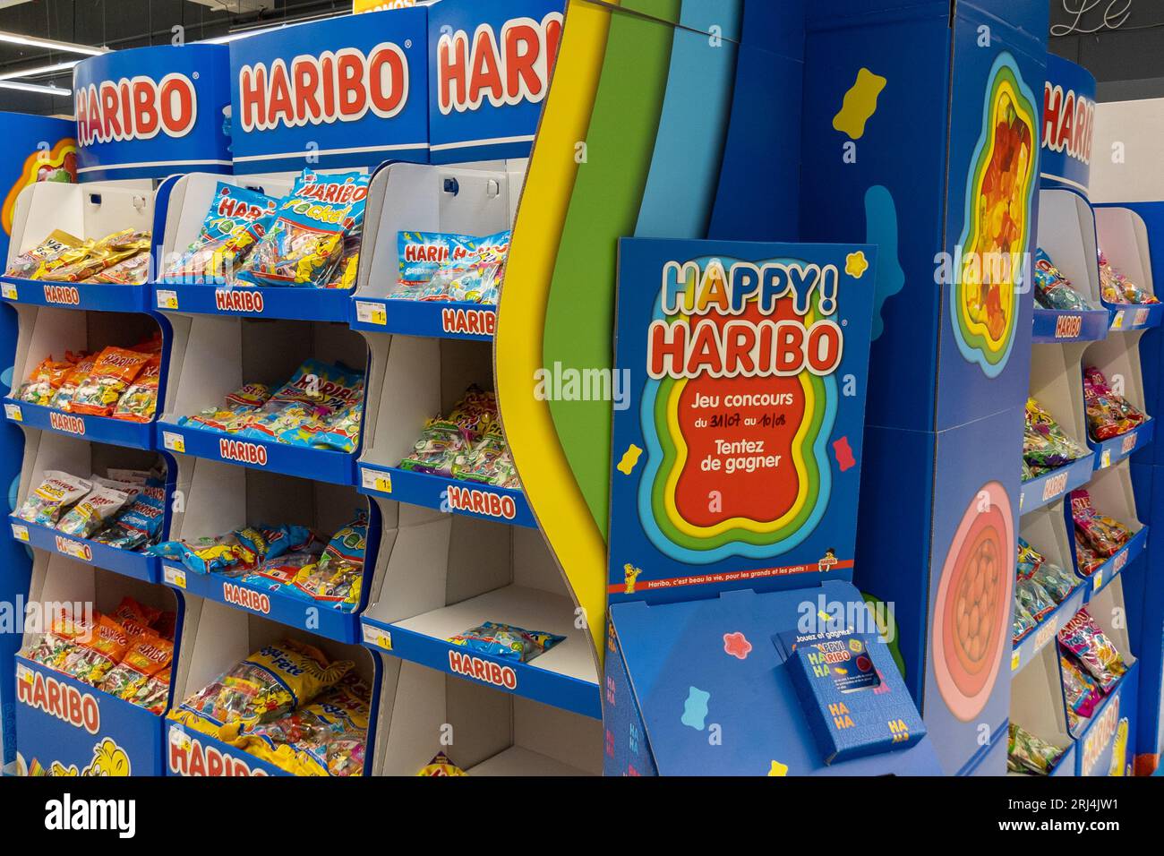 Saint-Gilles-Croix-de-Vie  France - 08 17 2023 : Haribo happy store advertising market shop logo brand and text sign chain display candies of German c Stock Photo