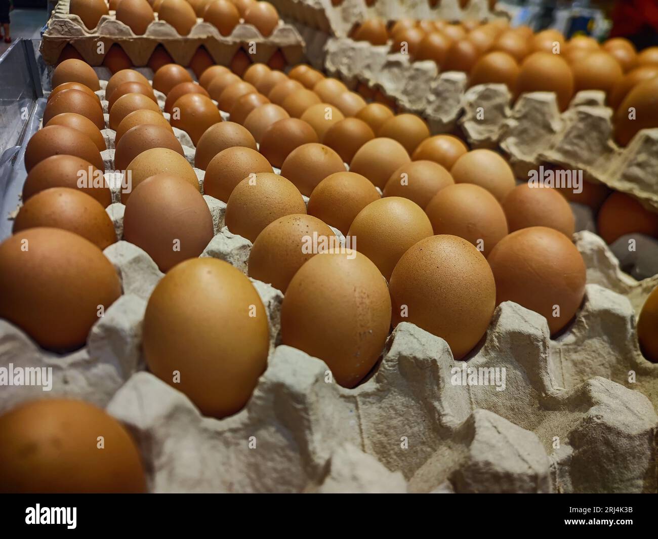 Brown chicken eggs in paper egg cartons are sold at the supermarket. Business and finance Photo. Stock Photo