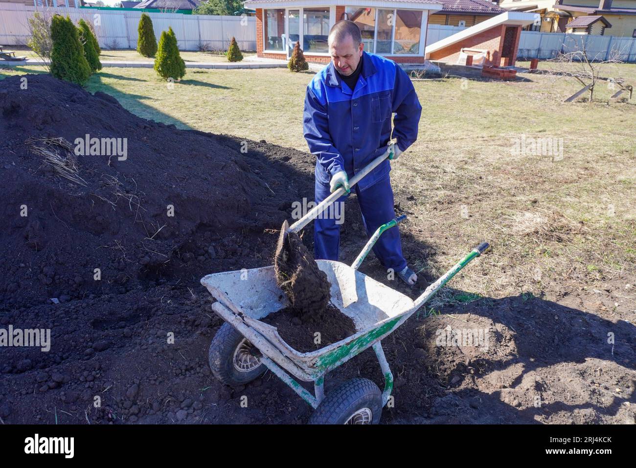 A man works in a vegetable garden in early spring. Digs the ground ...