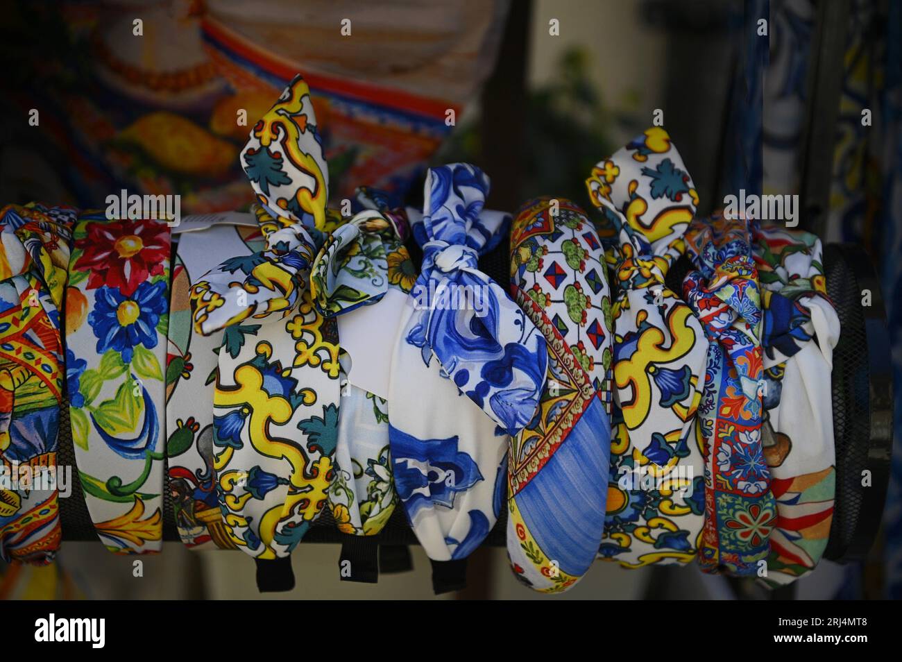 Display of patchwork printed Sicilian satin scarves with Sicilian