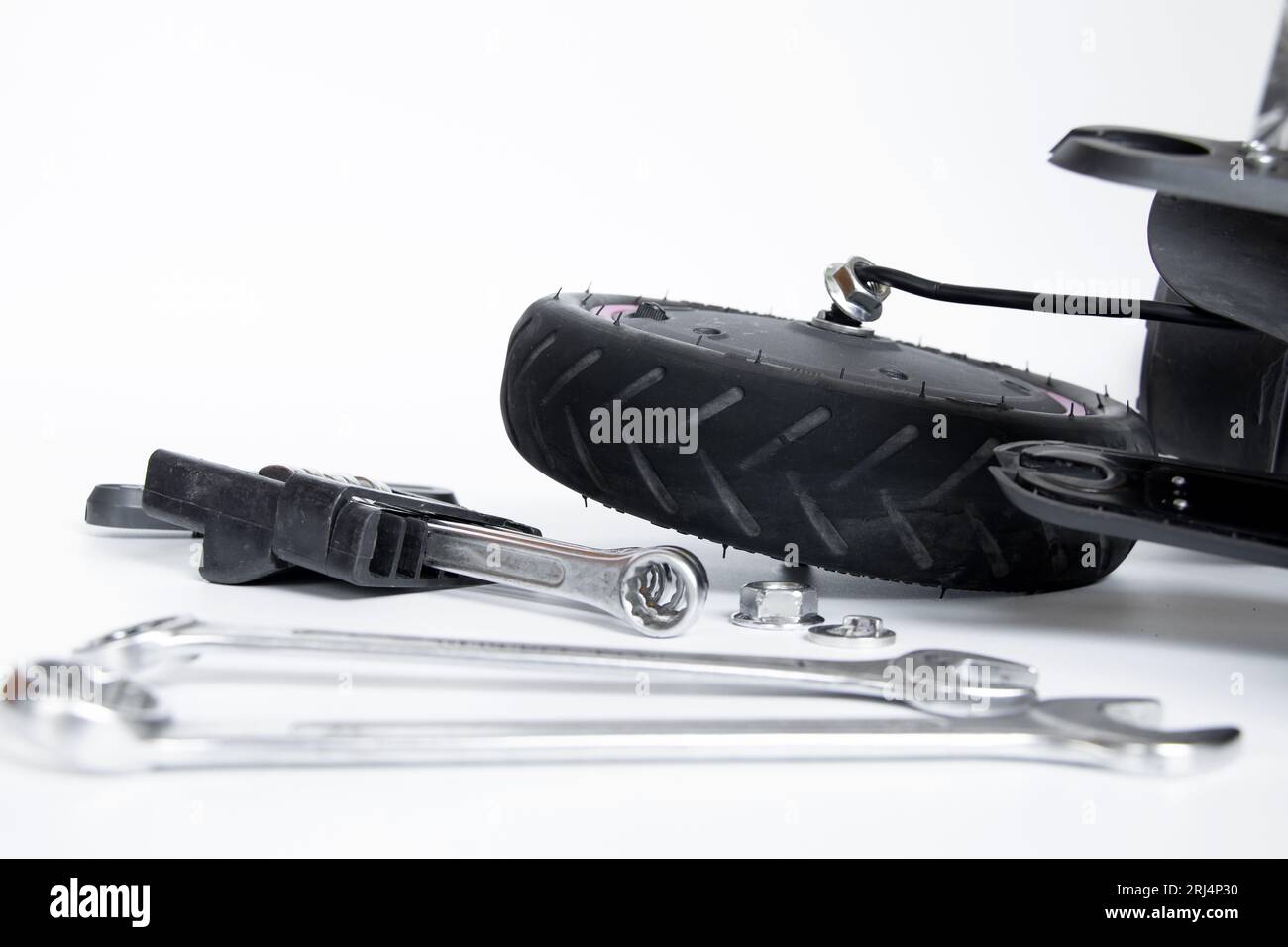 Disassembled electric scooter, wheel puncture and replacement with a