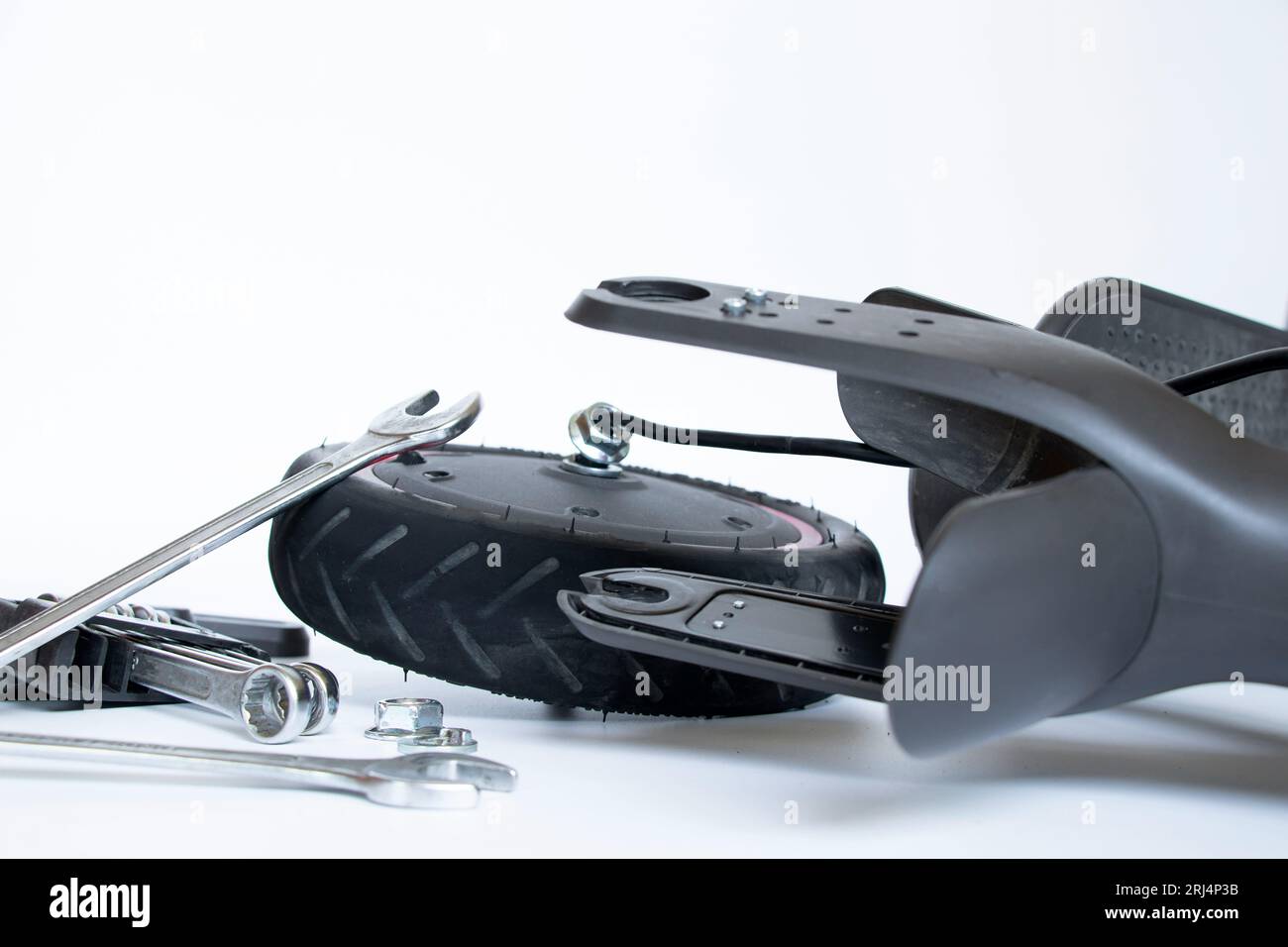 Disassembled electric scooter, wheel puncture and replacement with a