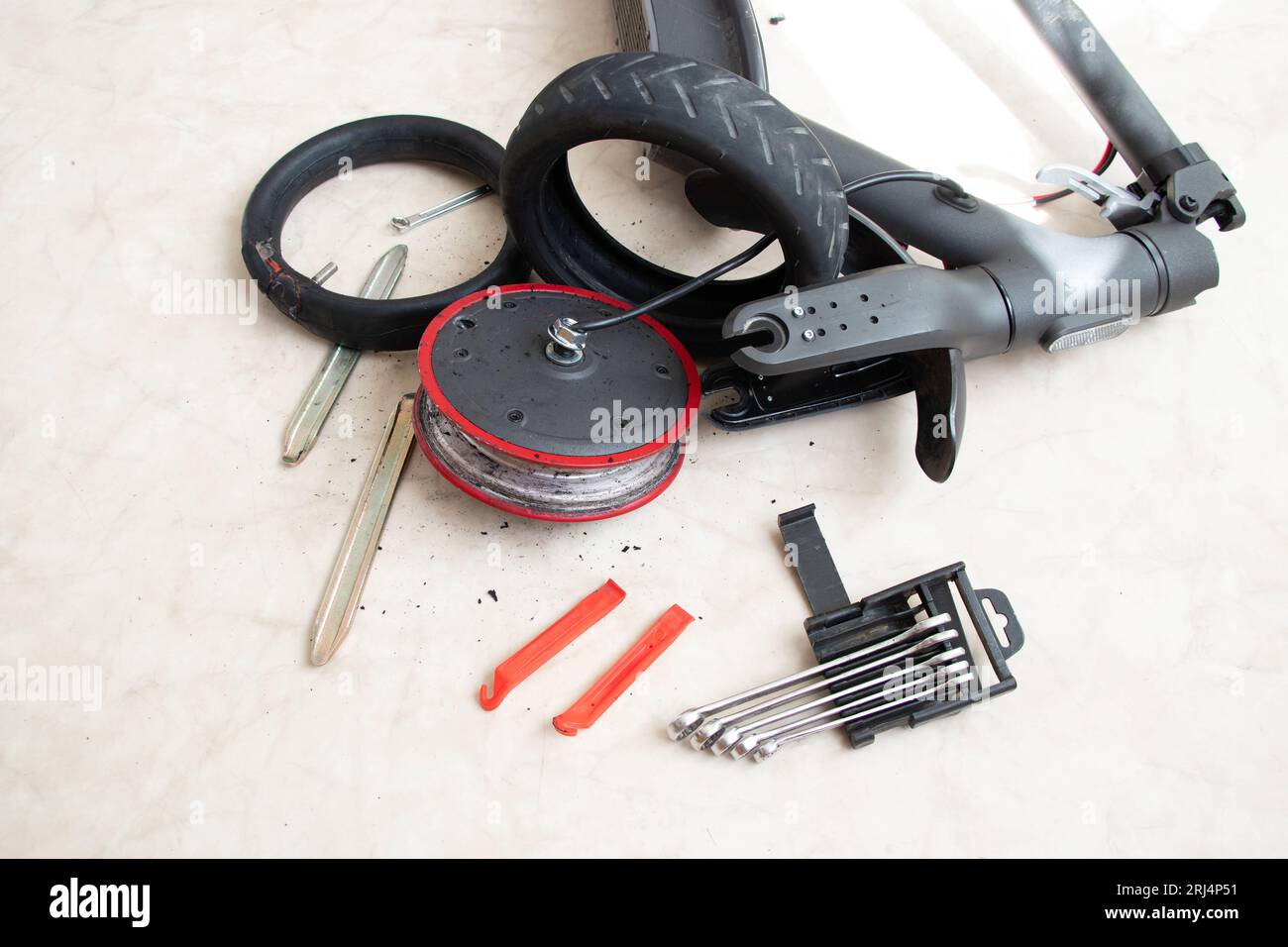 Disassembled electric scooter, wheel puncture and replacement with a