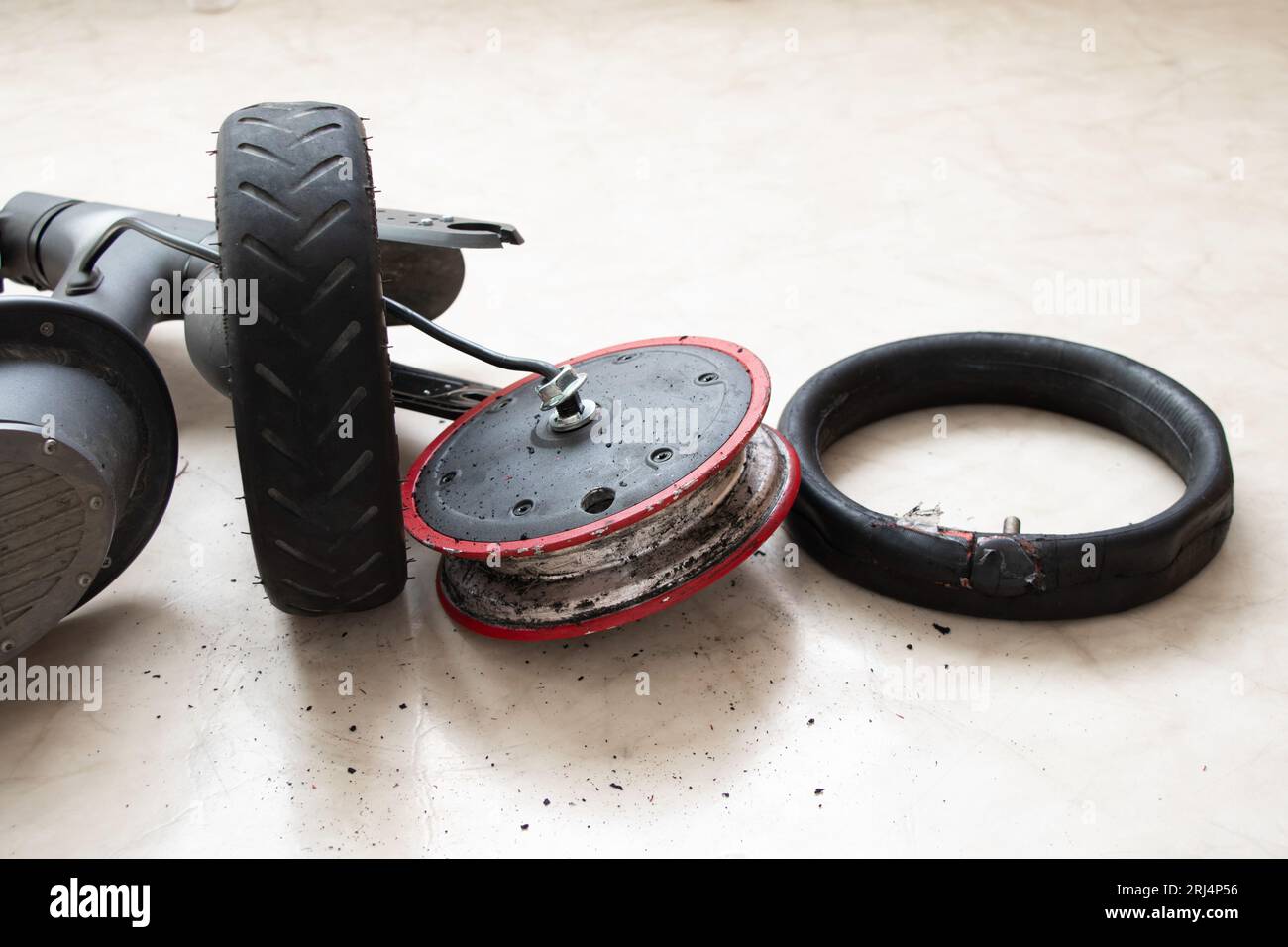 Disassembled electric scooter, wheel puncture and replacement with a