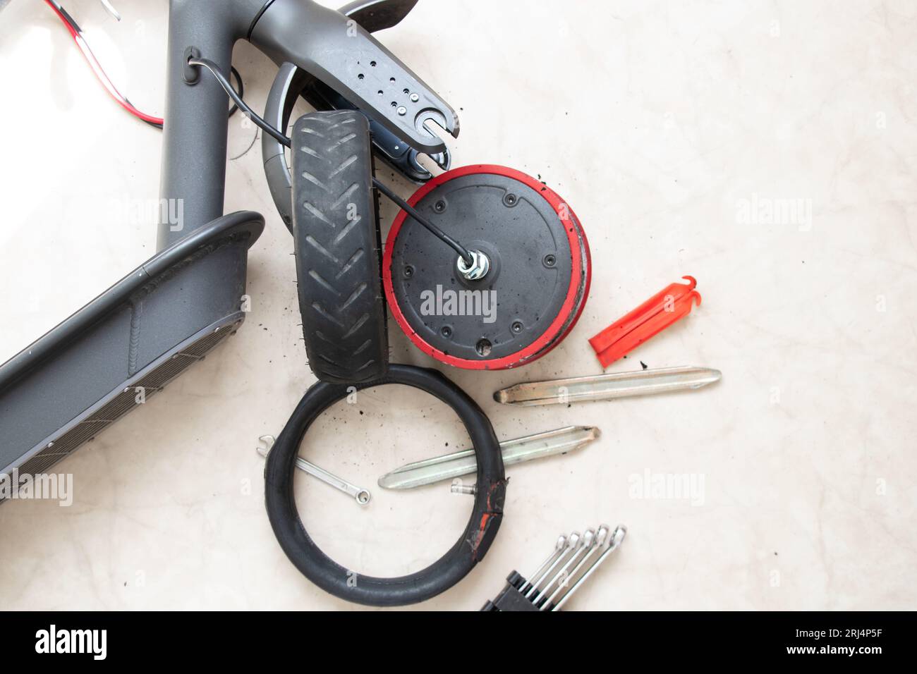 Disassembled electric scooter, wheel puncture and replacement with a