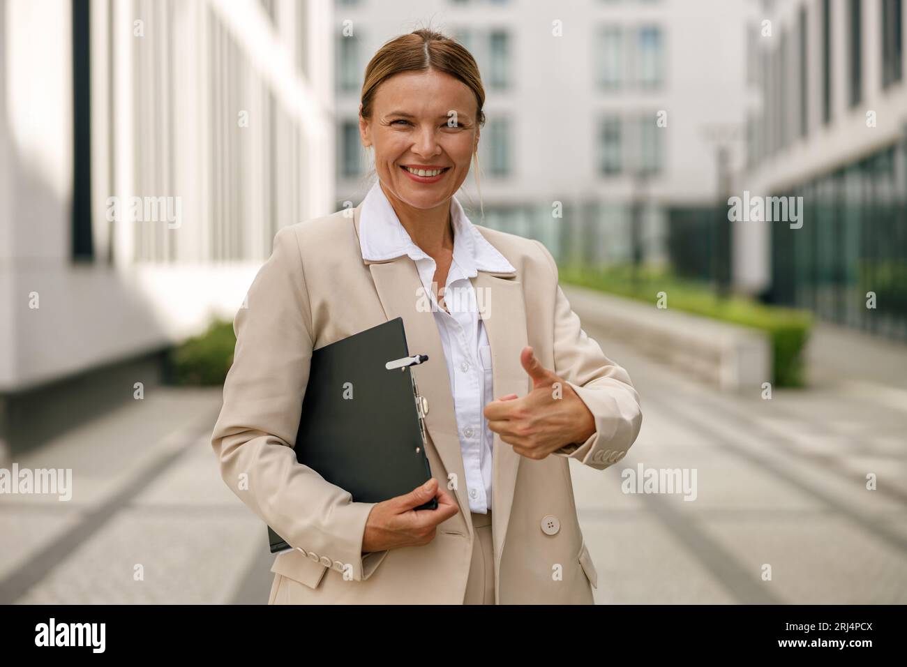 Serious young woman showing thumb hi-res stock photography and images ...