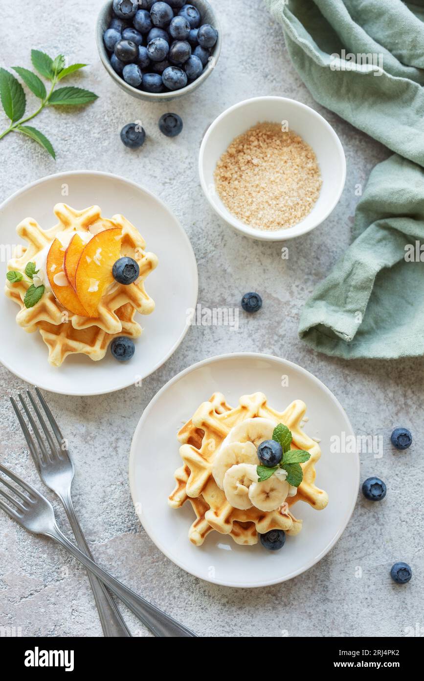 Belgian waffles with fruit, bananas and honey. Homemade baking. Concept of healthy breakfasts. Stock Photo