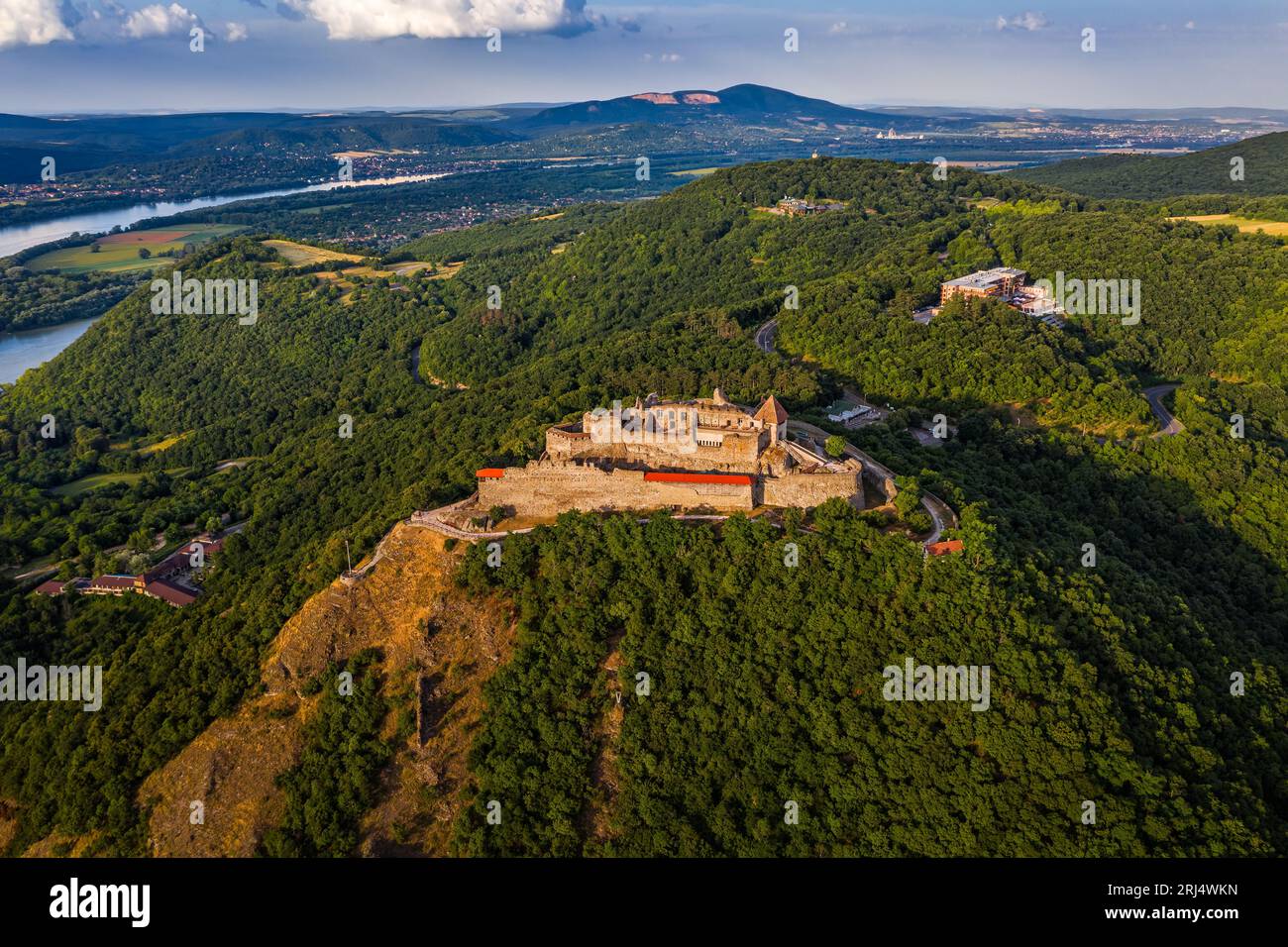 Visegrad, Hungary - Aerial drone view of the beautiful high castle of Visegrad with summer foliage and trees. Dunakanyar and blue sky with clouds at b Stock Photo