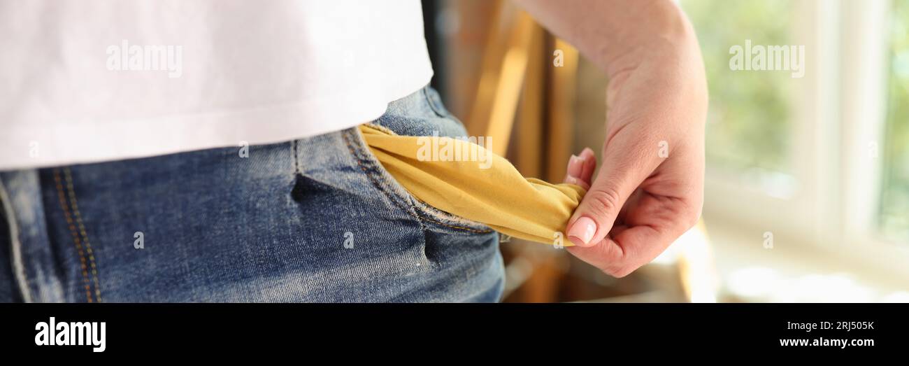 Close up of woman showing her empty pocket. Poverty, jobless and inflation concept. Stock Photo