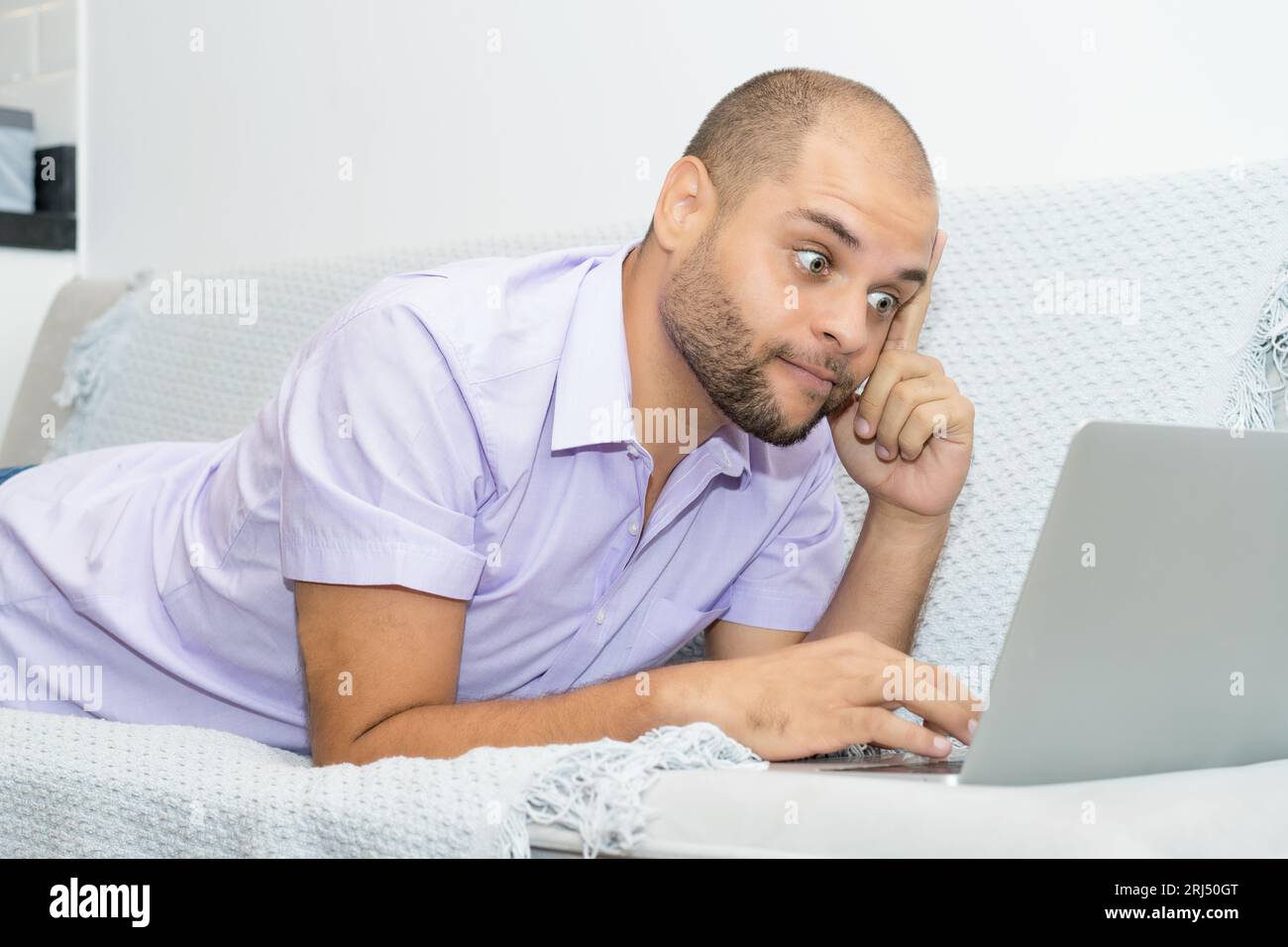 Male computer programmer solving problem indoors at home at couch Stock ...