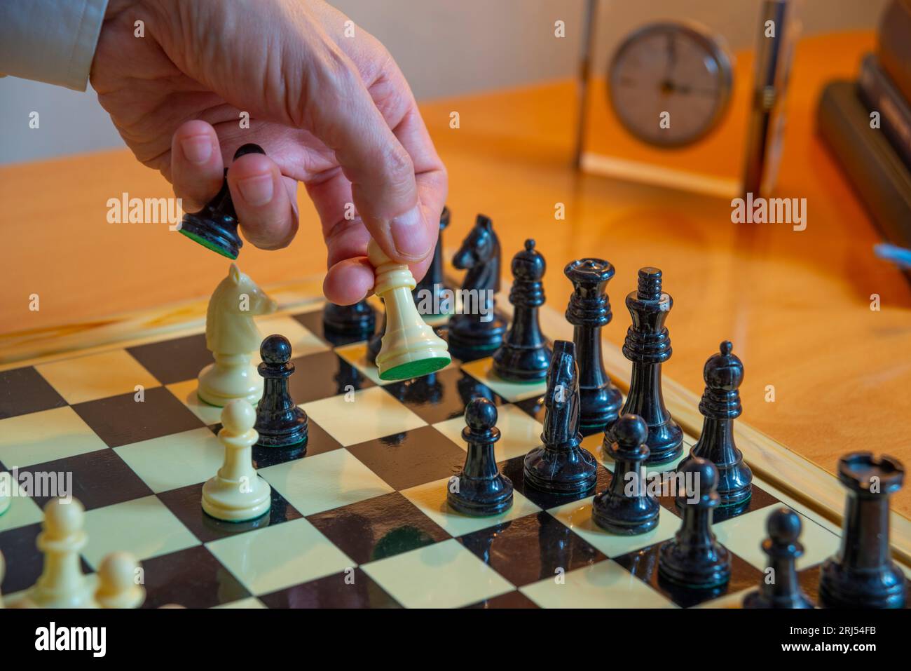 Man's hand playing chess. Stock Photo