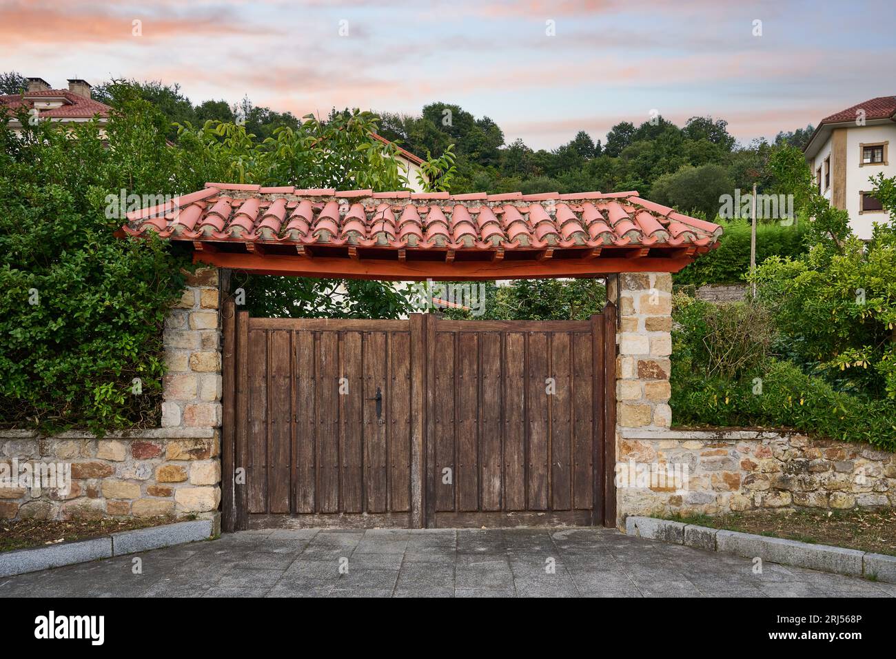 Rustic access porch to the farm with wooden door and upper roof with tile Stock Photo