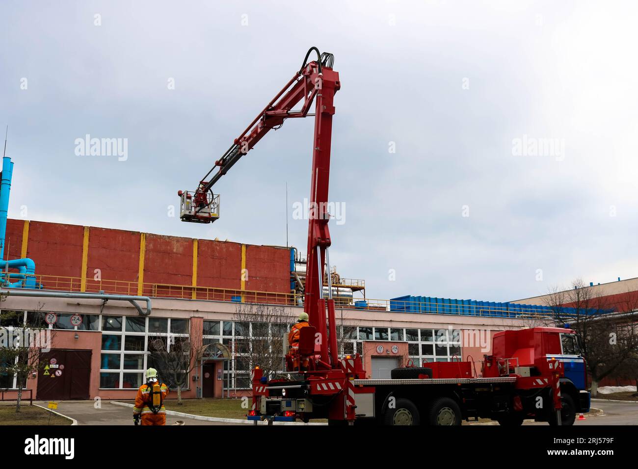 Firefighter rescuers at work in fireproof suits came to extinguish a