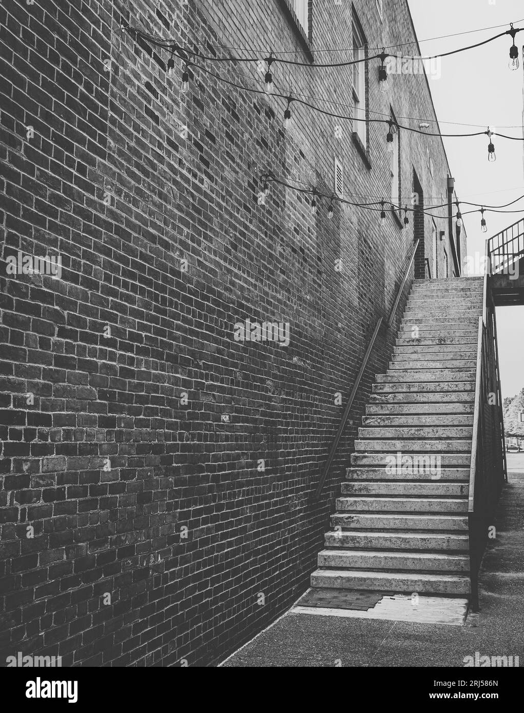 A brick building wall beside a staircase Stock Photo Alamy