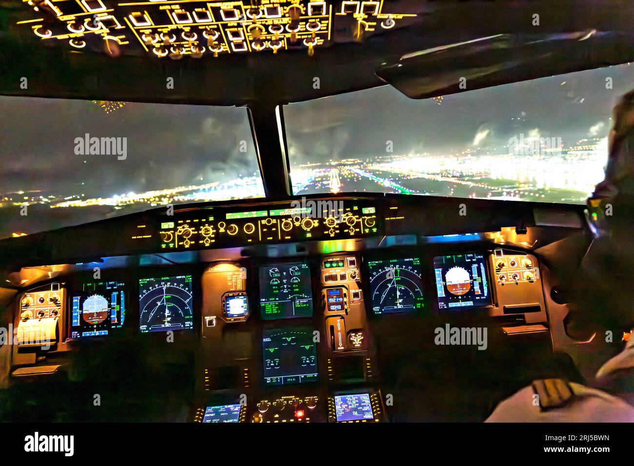 Frankfurt, Germany -October 9, 2014: landing by night with a commercaial aircraft A320 at the airport of Frankfurt, Germany. Stock Photo