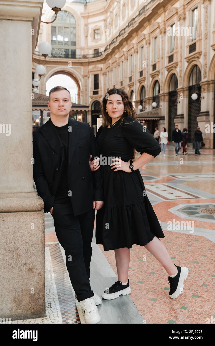 Young stylish man and woman in Vittorio Emanuele Gallery in Milan Stock Photo