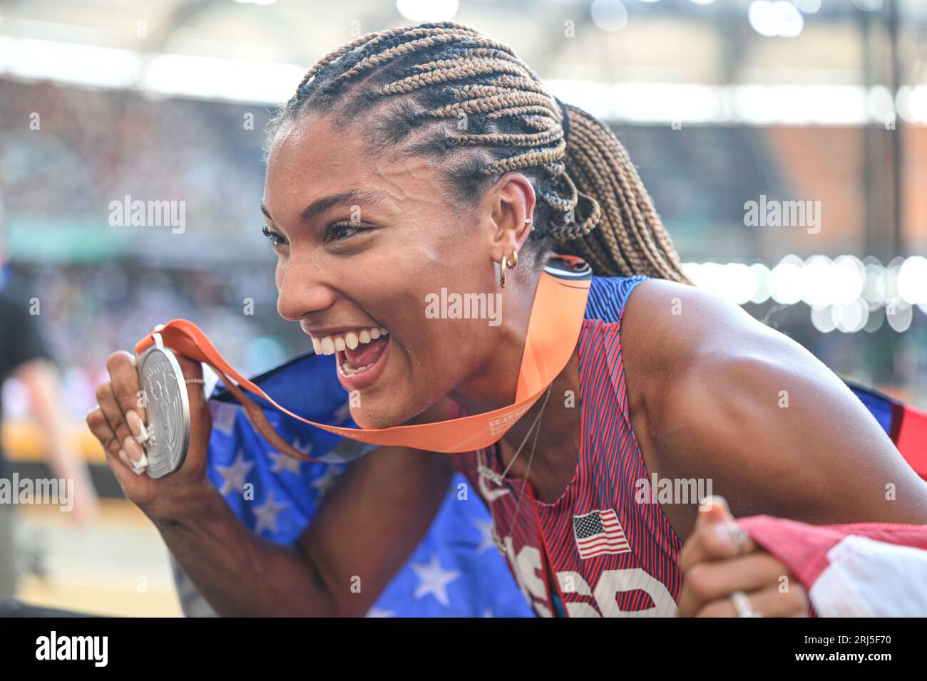 Tara Davis celebrating the second place with her country's flag in the
