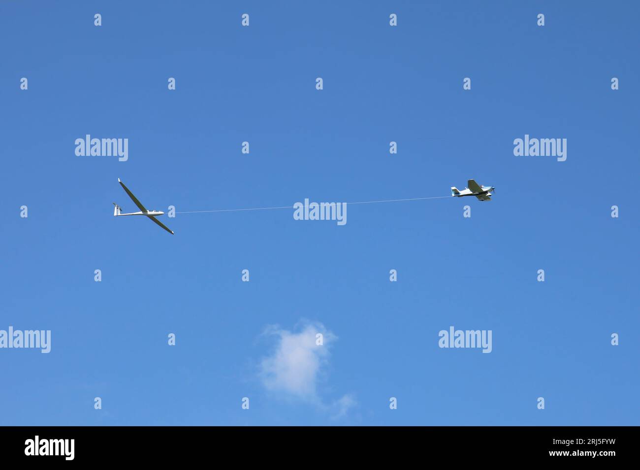 A scenic view of a Glider is pulled up to altitude by a powered