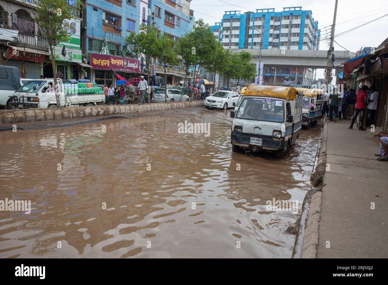 Human howlers on a submerged road at Jurain in Dhaka, Bangladesh Stock