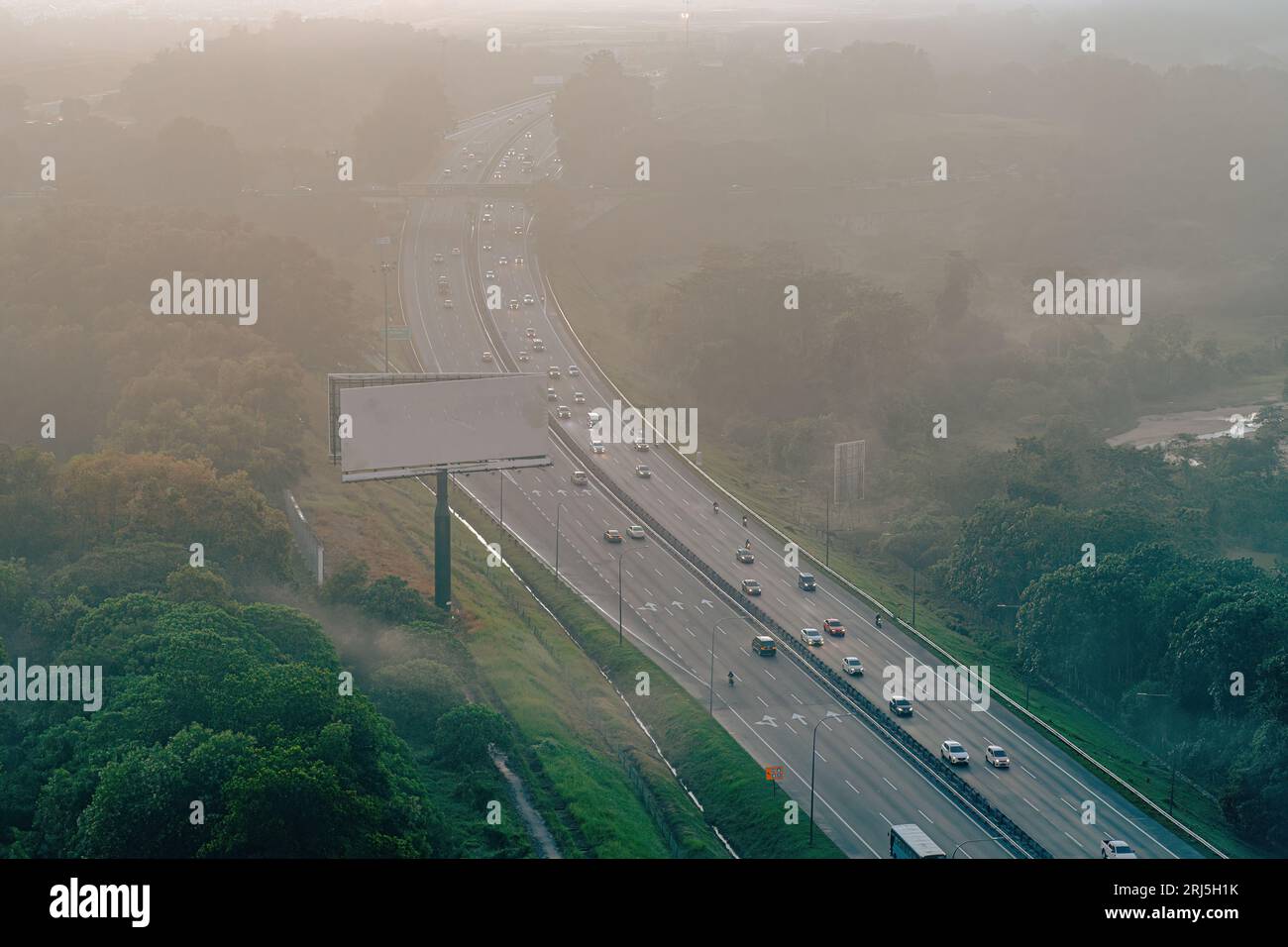 An aerial view of a highway at a foggy sunset Stock Photo