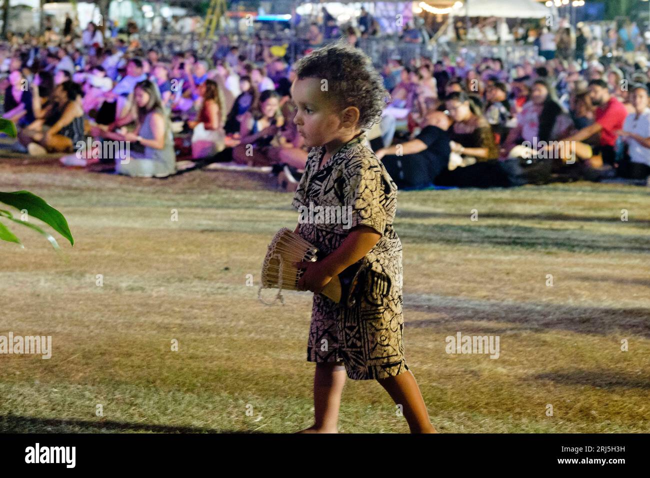 Honolulu, Hawaii, USA. 20th Aug, 2023. At the end of the evening a child dances at the Maui Ola Benefit Concert held on the lawn at the Bishop Museum and which raised over $500,000 for Maui wildfire relief. 23.08.20 (Credit Image: © J. Matt/ZUMA Press Wire) EDITORIAL USAGE ONLY! Not for Commercial USAGE! Stock Photo