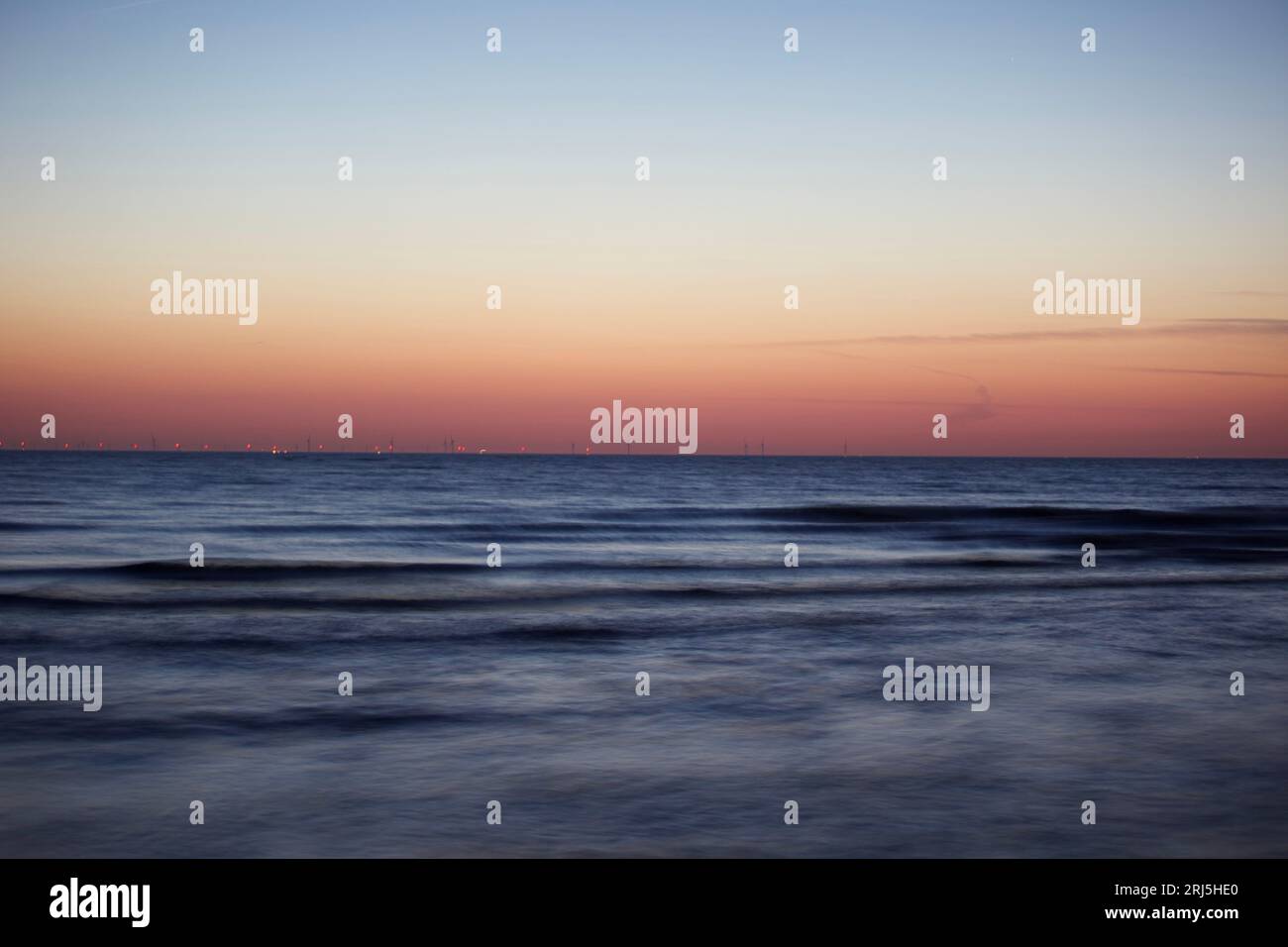 The calm ocean and a clear sky at dusk Stock Photo - Alamy