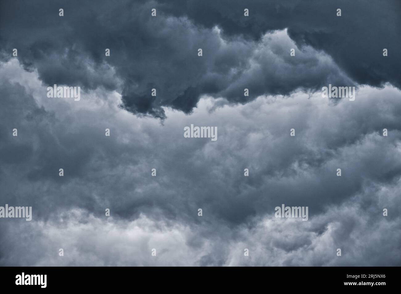 Dark clouds before the rain, used to make a background image. Dramatic sky with dark clouds. Stock Photo