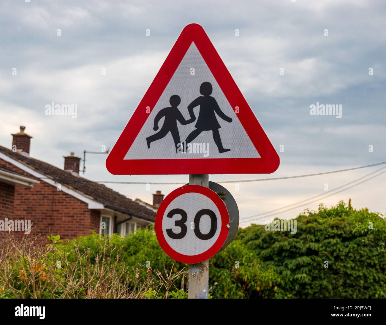 children crossing road sign, Castle Hedingham, Essex England UK Stock Photo