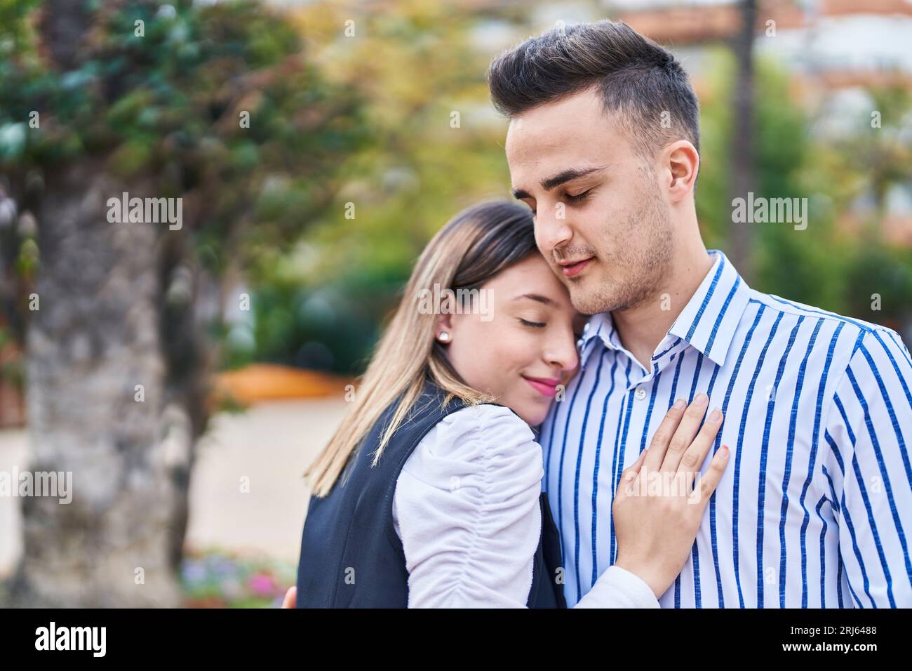 Man and woman couple smiling confident hugging each other at park Stock ...