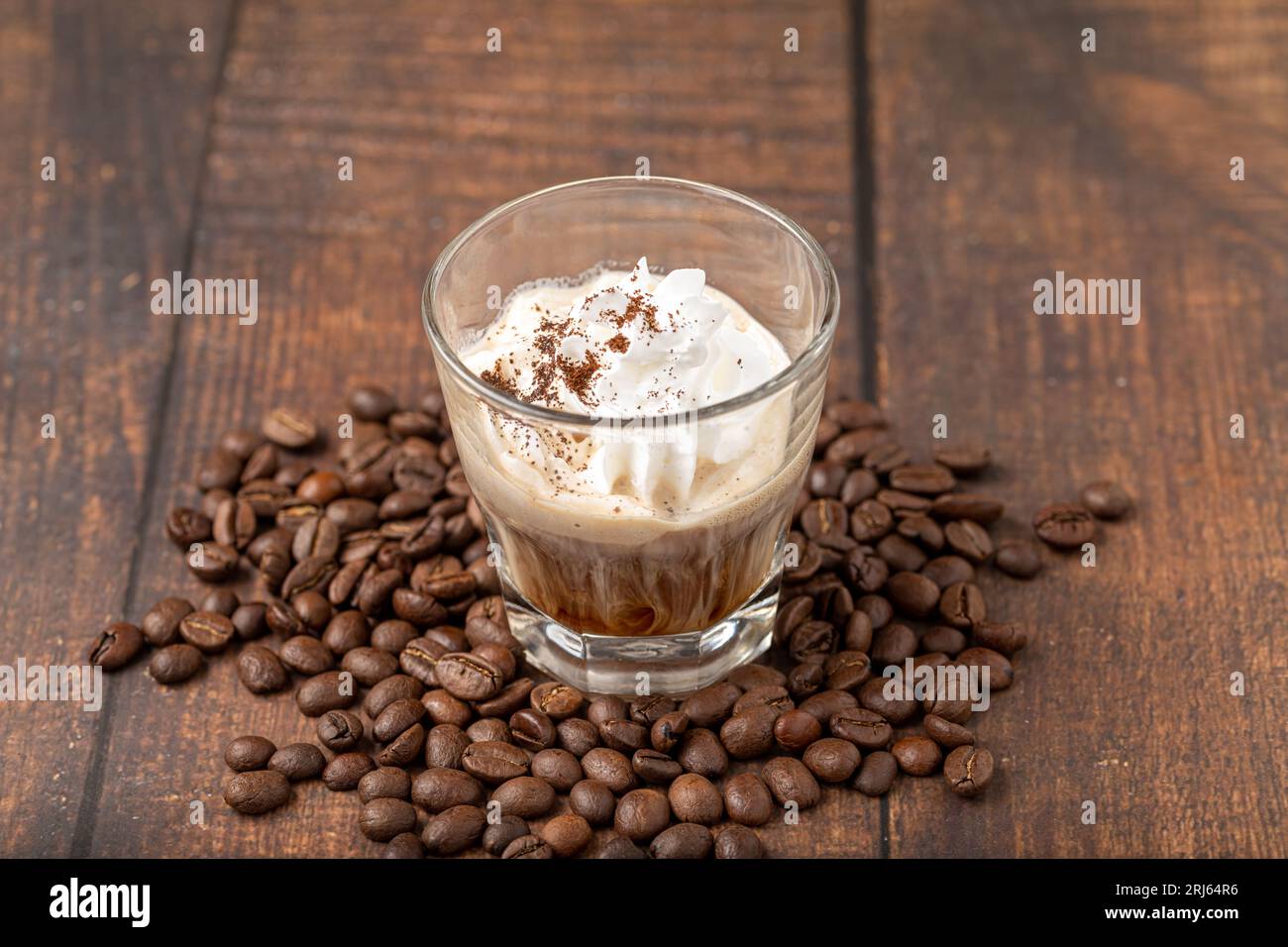 Hot espresso con panna in glass cup on wooden table Stock Photo
