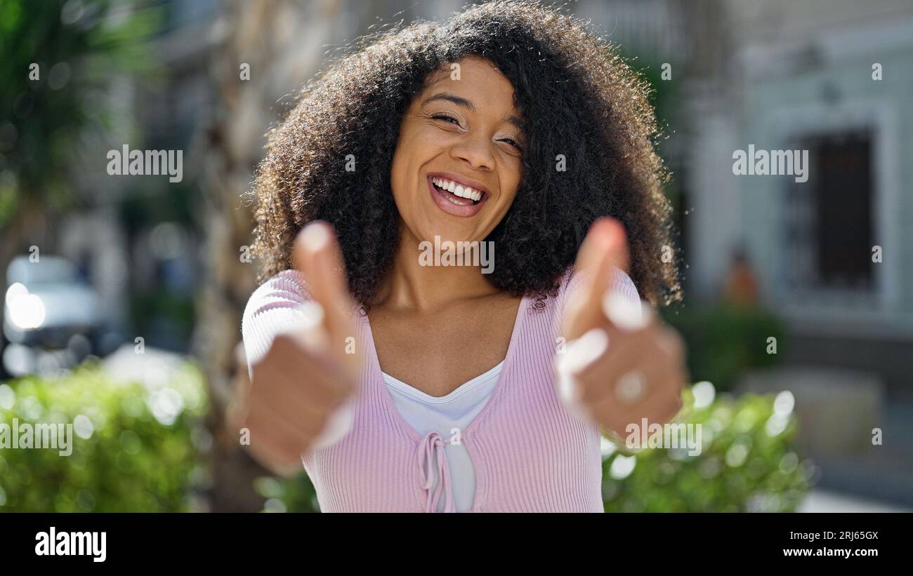 African american woman smiling confident doing ok sign with thumbs up ...