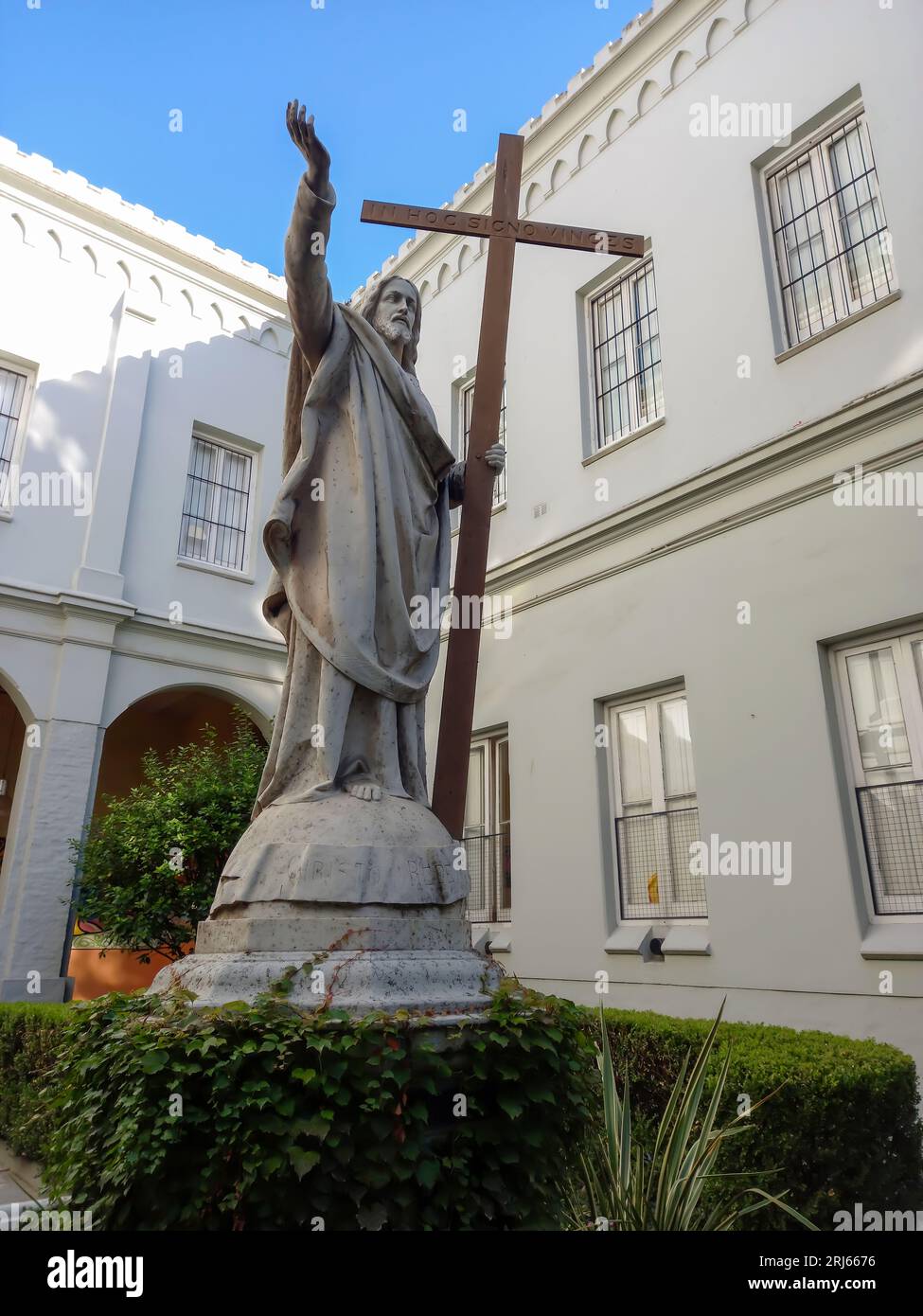 Statue of Jesus Christ with the cross pointing the sky with his hand in