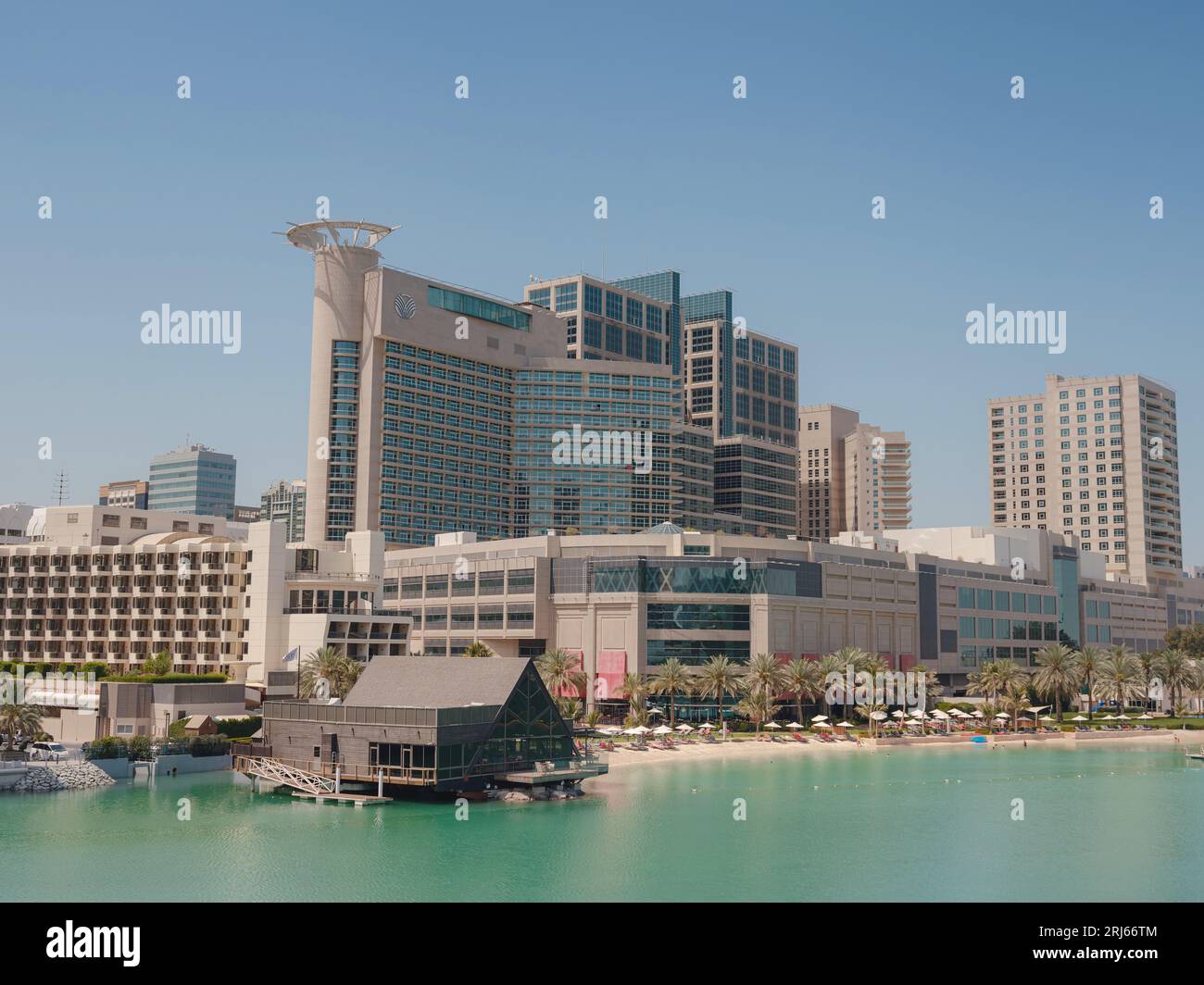 Abu Dhabi, UAE - March 19, 2023: Abu Dhabi Mall and Beach Rotana Hotel. View from the water, of the Beach Rotana Hotel and the Abu Dhabi Mall, with reflections. Stock Photo